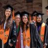 Graduating students in regalia pose before processional