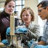 Students working with professor in lab