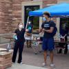 Volunteers test students at a collection station outside of the Athletics Department