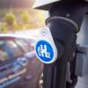 A hydrogen fuel station pump with car in background