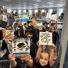 Children holding up their artwork.