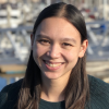 Kara Fong in dark sweater with boats out of focus in background