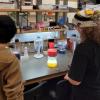Northglenn high school students standing at the bench in the Shields Lab