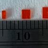 Orange crystals grown by one of Mike Tooney's undergraduate students are next to a ruler.
