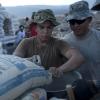 Workers mixing cement on Army construction project