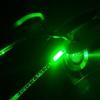 A pipette tip prototype illuminated by green light