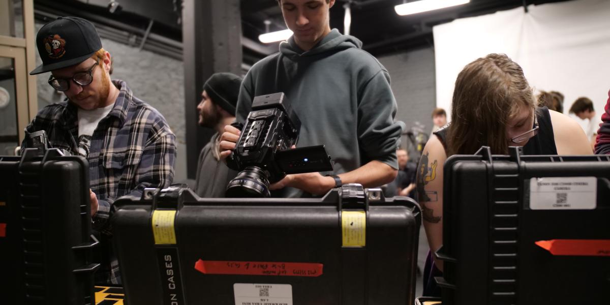 student holding camera