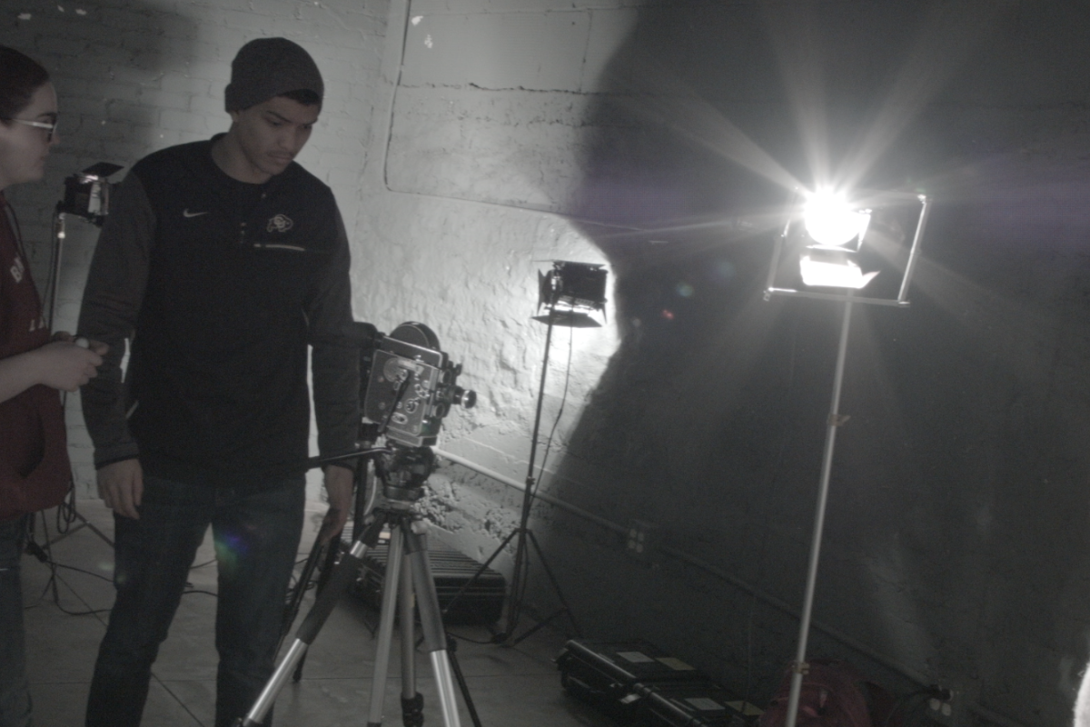 Students working on lighting a set