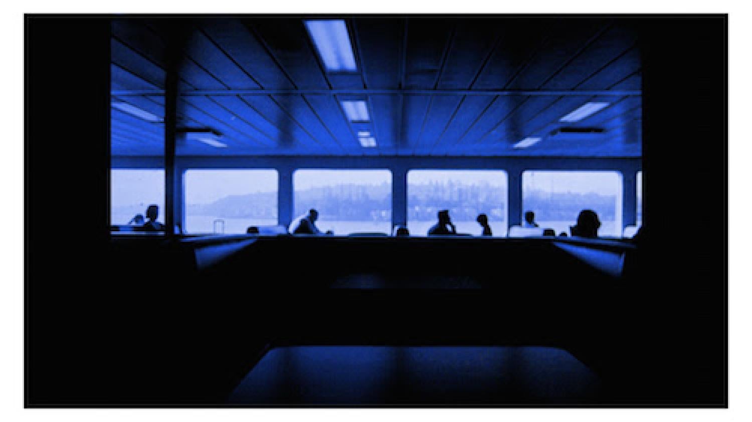people on the lower deck of a ferry