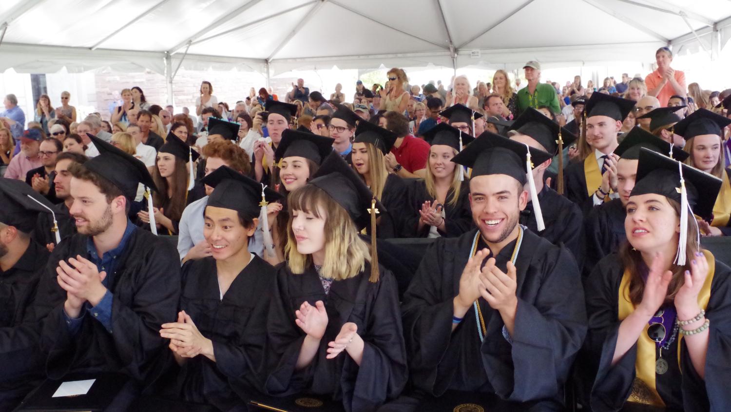 Graduating students clapping