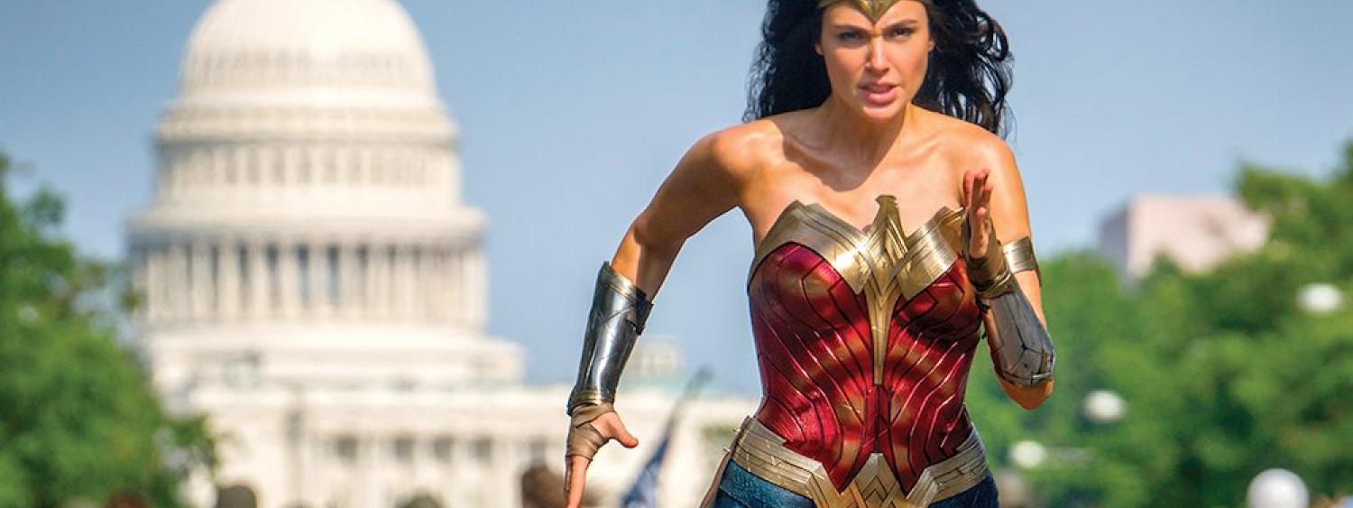 Gal Gadot as Wonder Woman in Wonder Woman 1984. Gadot runs in front of the white house