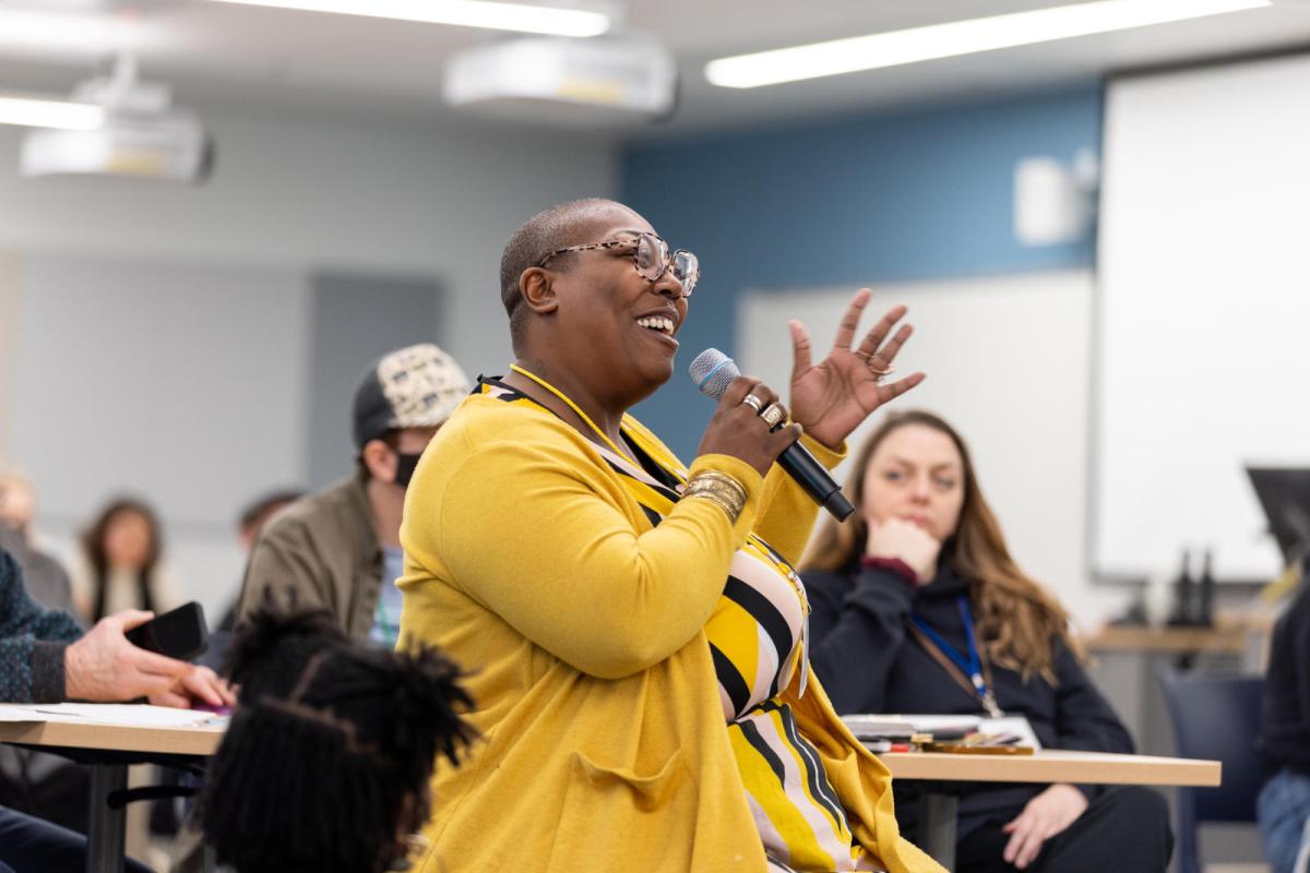 woman speaking in front of audience