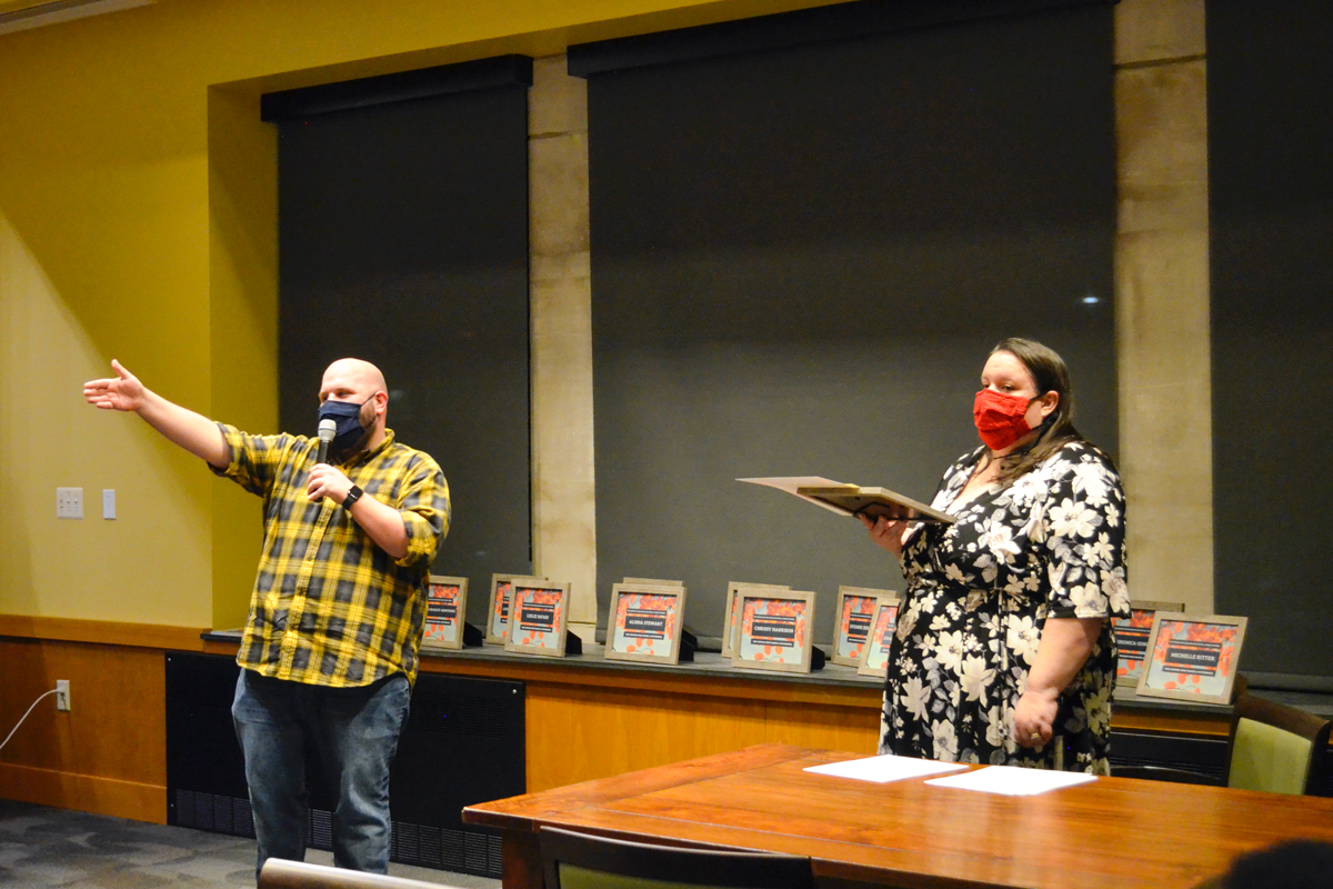 Amanda Linsenmeyer and other center staff present awards at Women Who Make A Difference event