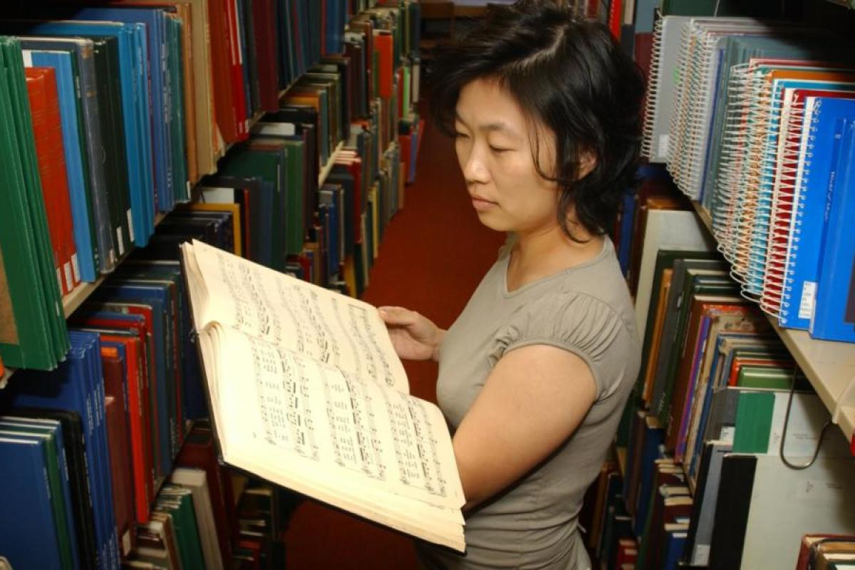 Woman in library looking at books