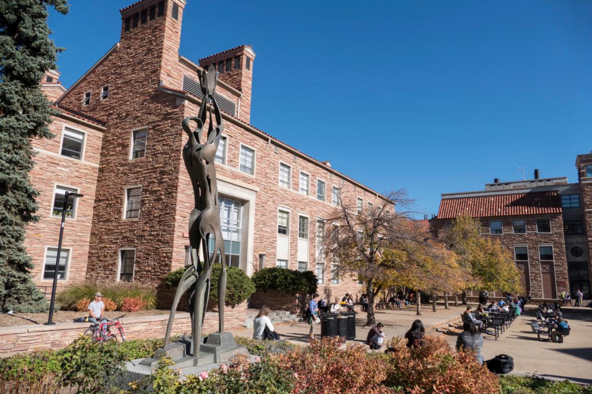 a sculpture of a person with their arms held up in the UMC fountain plaza