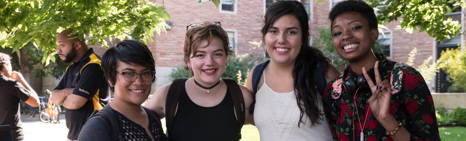 Four students posing and smiling