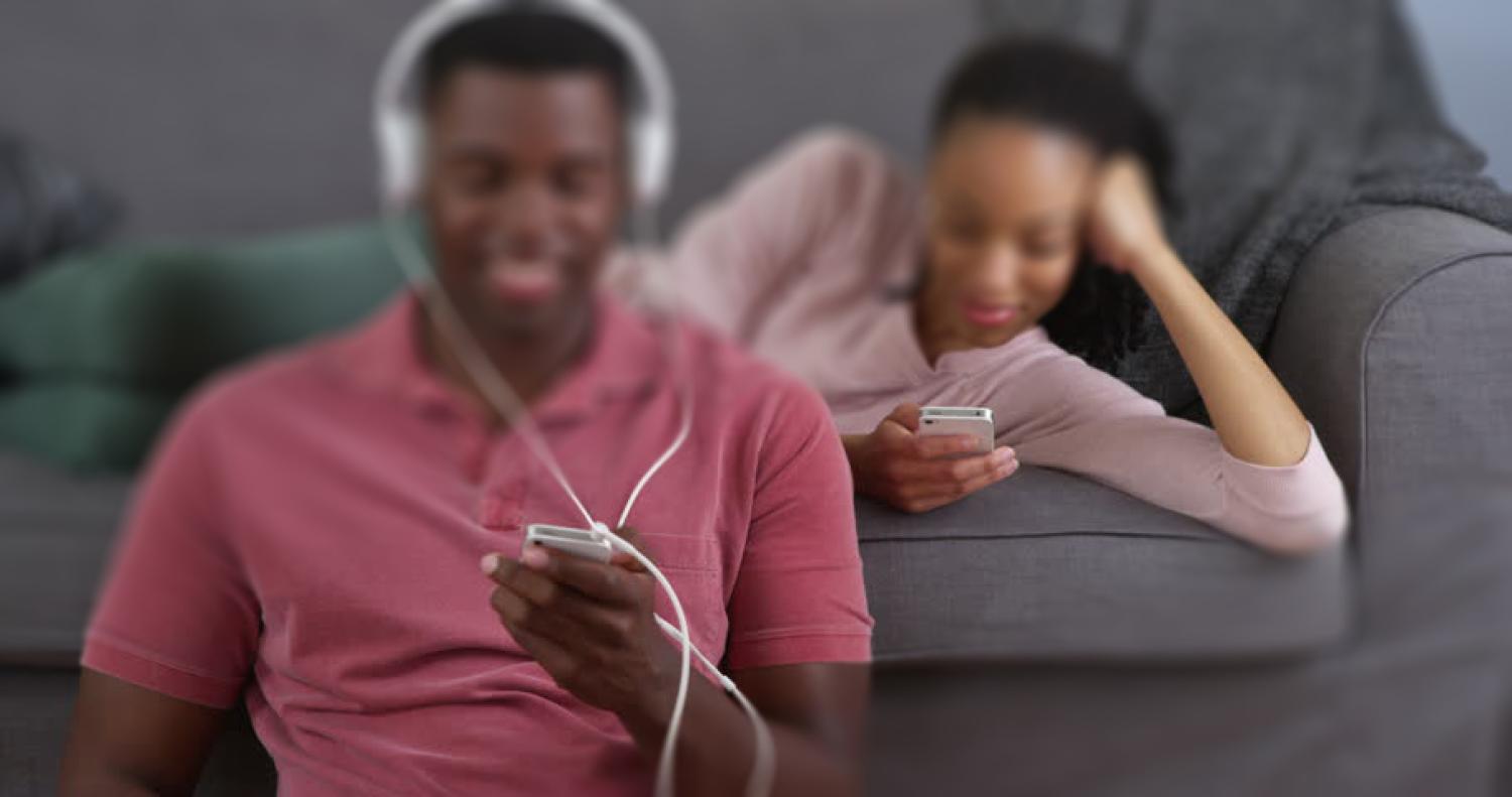 two people listening to electronic devices