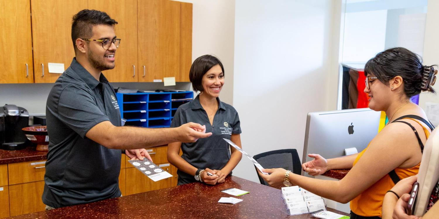 The Center staff helping students at front desk