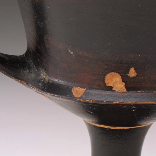 stem at attachment to cup; breaks