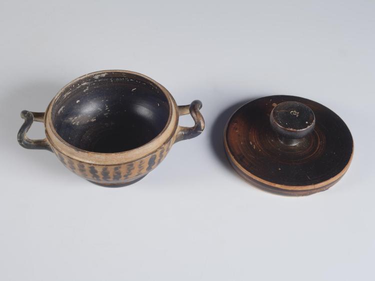 Photograph of a lekanis and its lid, place side-by-side, from a high angle against a neutral gray background