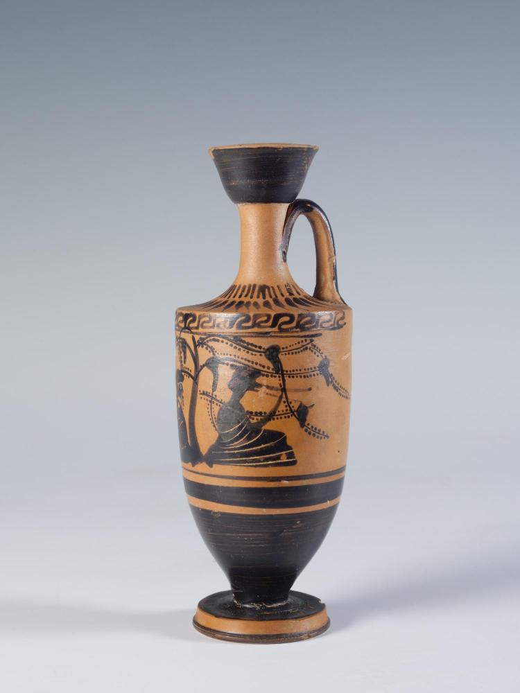 Photograph of a lekythos, focused on right side of decorative panel, from the side against a neutral gray background.