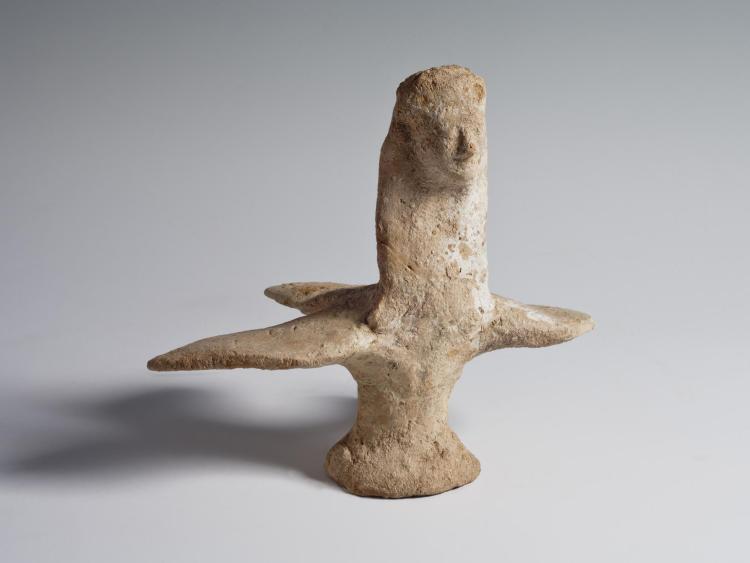 Photograph of a terracotta figurine of a harpy, slightly angled toward viewer's right shoulder, from the side against a neutral gray background.