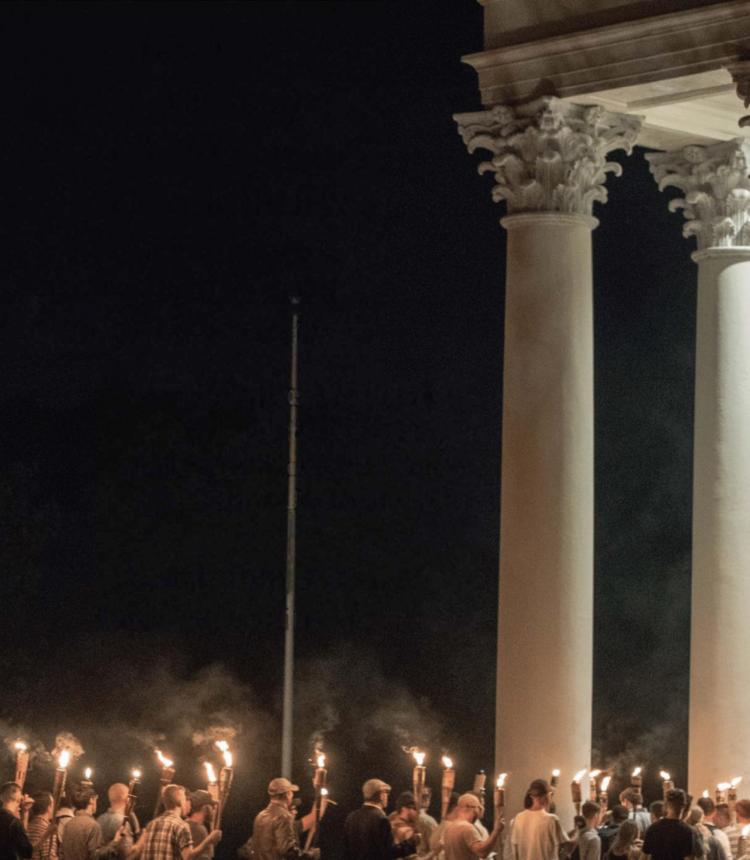 Image of students marching with torches at a university