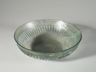 Photo of a clear glass bowl, from a high angle against a neutral gray background.
