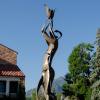 Statue of person holding fire aloft