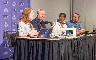 A panel of students and faculty answer questions at the expo.