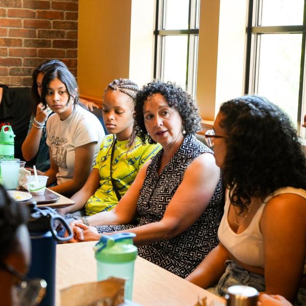 Lisa Flores, associate dean of diversity, equity and inclusion and a communication professor, speaks with Connections students at the C4C after dinner on their first night.
