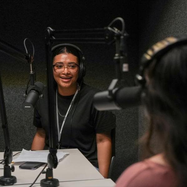 Connections participant Alexandra Corsino records a podcast in a CMCI sound booth.