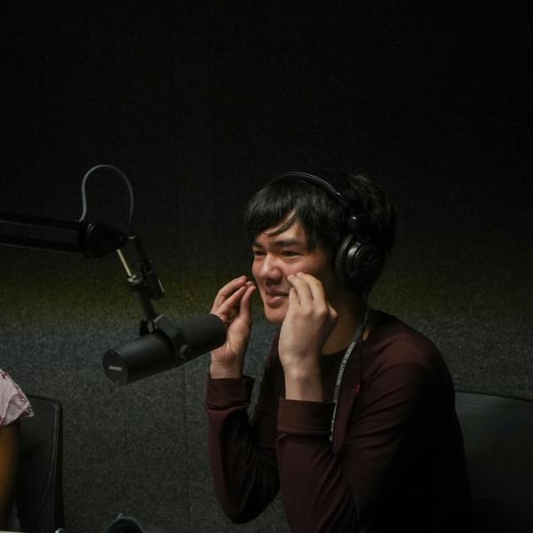 Connections participant Lhaten Wood records part of a podcast in a sound booth. CMCI students have access to several sound booths located in the CASE building.