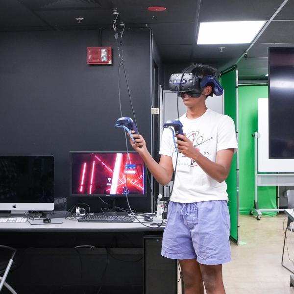 Pathways student Samson Kidane uses virtual reality goggles.
