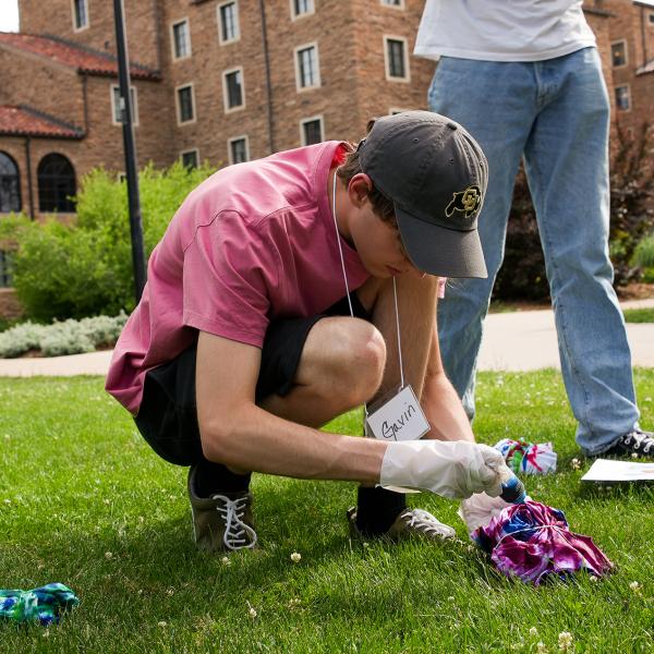Pathways student Gavin Faulkner tie-dyes his shirt on the first day of the summer intensive program.