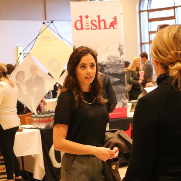 A representative talking with students at the career fair