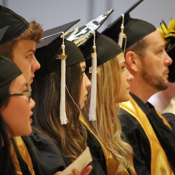 Graduates wait to receive their degrees.