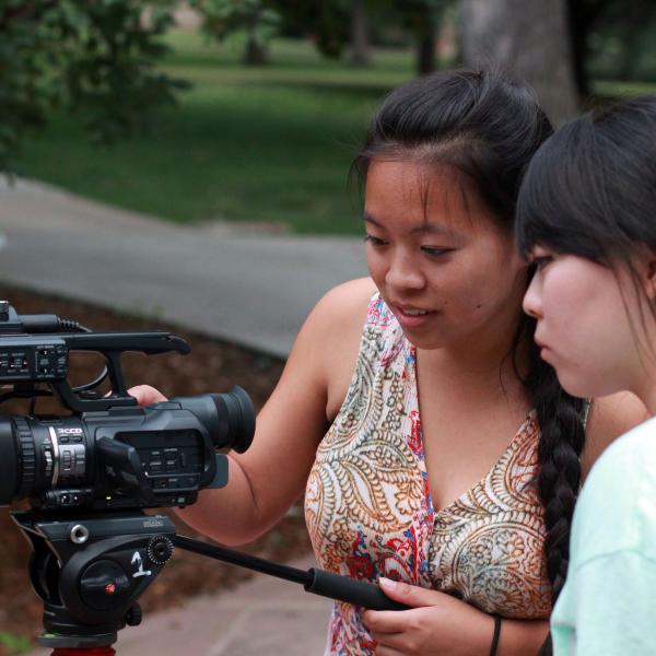 Marissa Kelley and Kristin Jihye Oh get familiarized with a video camera, part of the intensive's training on broadcast equipment.