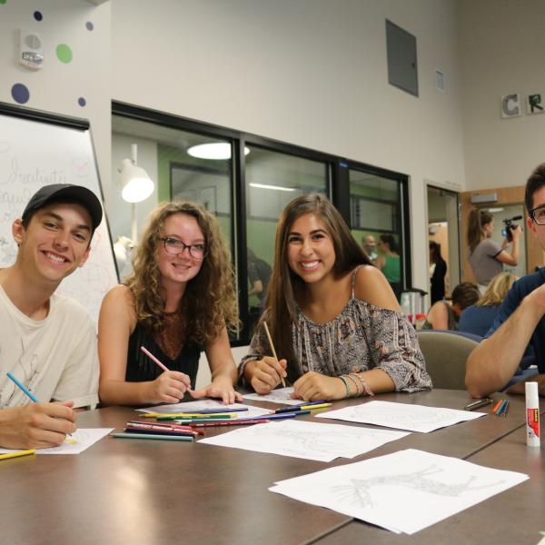 Project members pose with the new coloring resources