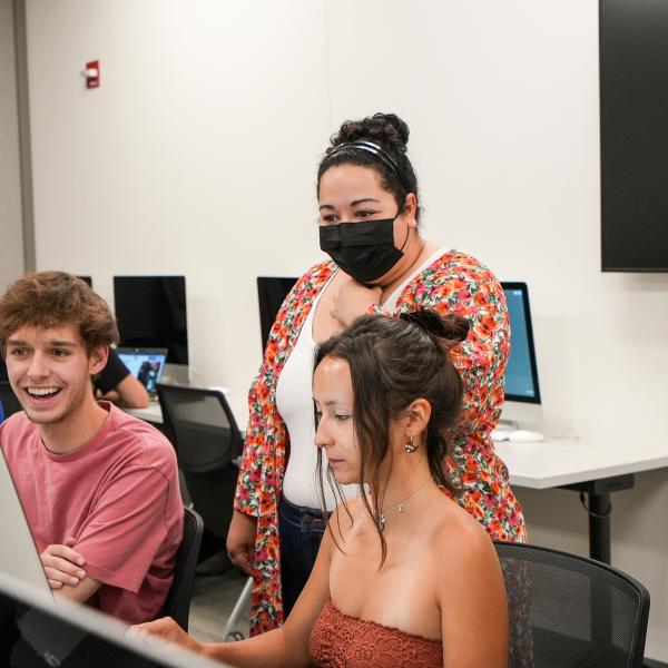 Logan Gomez, a PhD student in communication, gives advice to Pathways students Sierra Dunham and Gavin Faulkner.