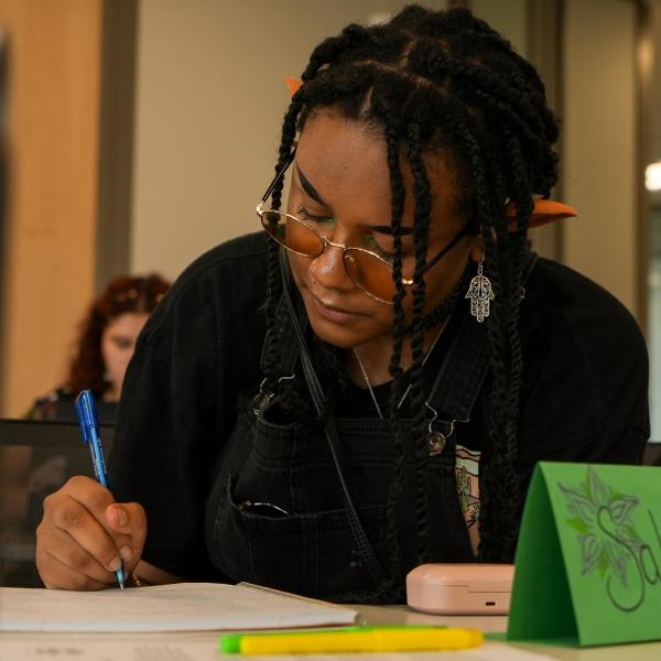 Connections student Salem Hill writes about their name in instructor Orly Hersh’s class.