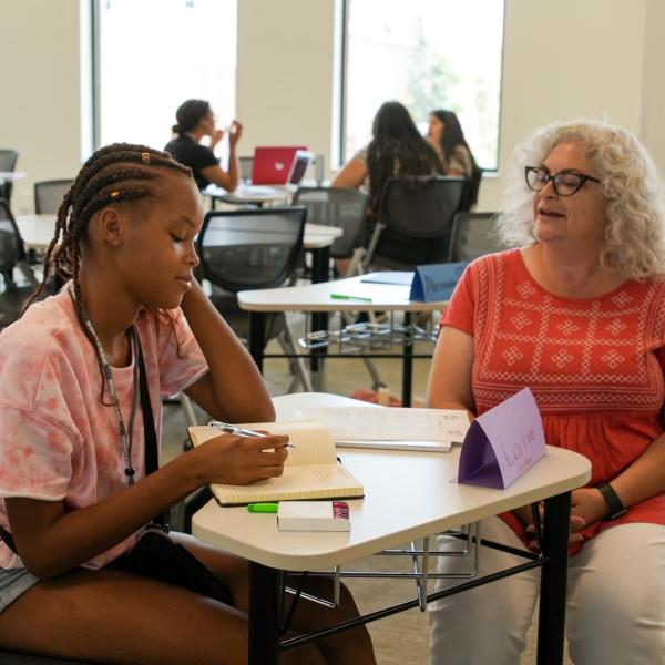 Instructor Orly Hersh works with high school student Car'rie Robinson on a project in which students wrote about the meaning of their names.