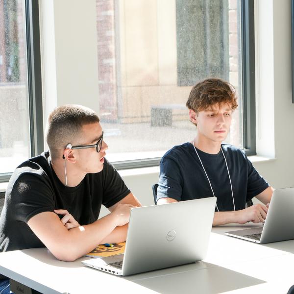 Pathways students Cruz Miranda and Gavin Faulkner work together during a Sports Journalism class.