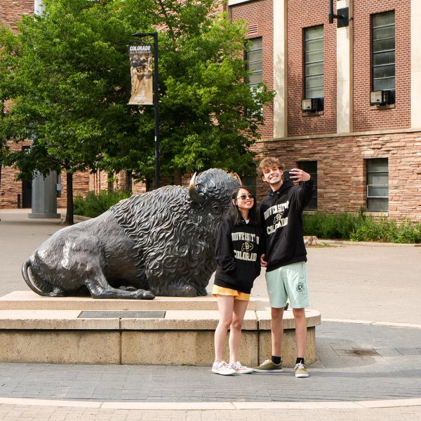 Pathways students Amy Kibort and Gavin Faulkner take a photo in front of the Ralphie statue during their scavenger hunt around campus.