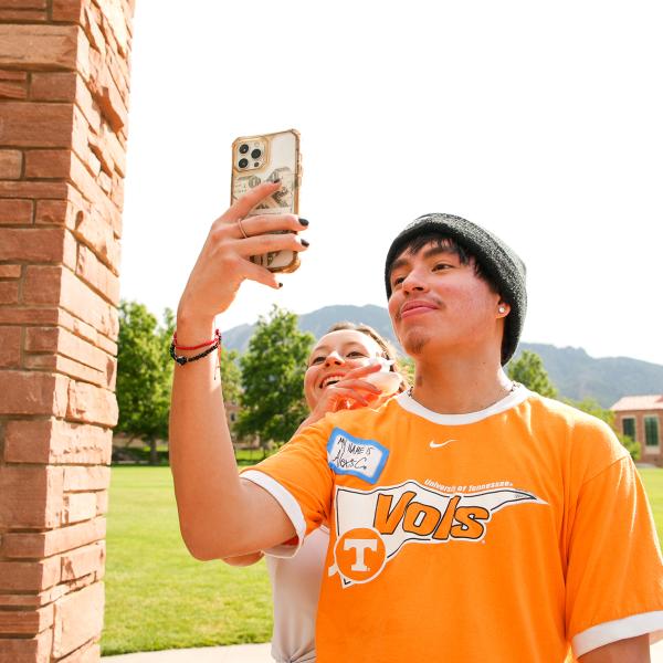 Pathways students Sierra Dunham and Alexis Campos take a photo together at Farrand Field during a campus scavenger hunt.