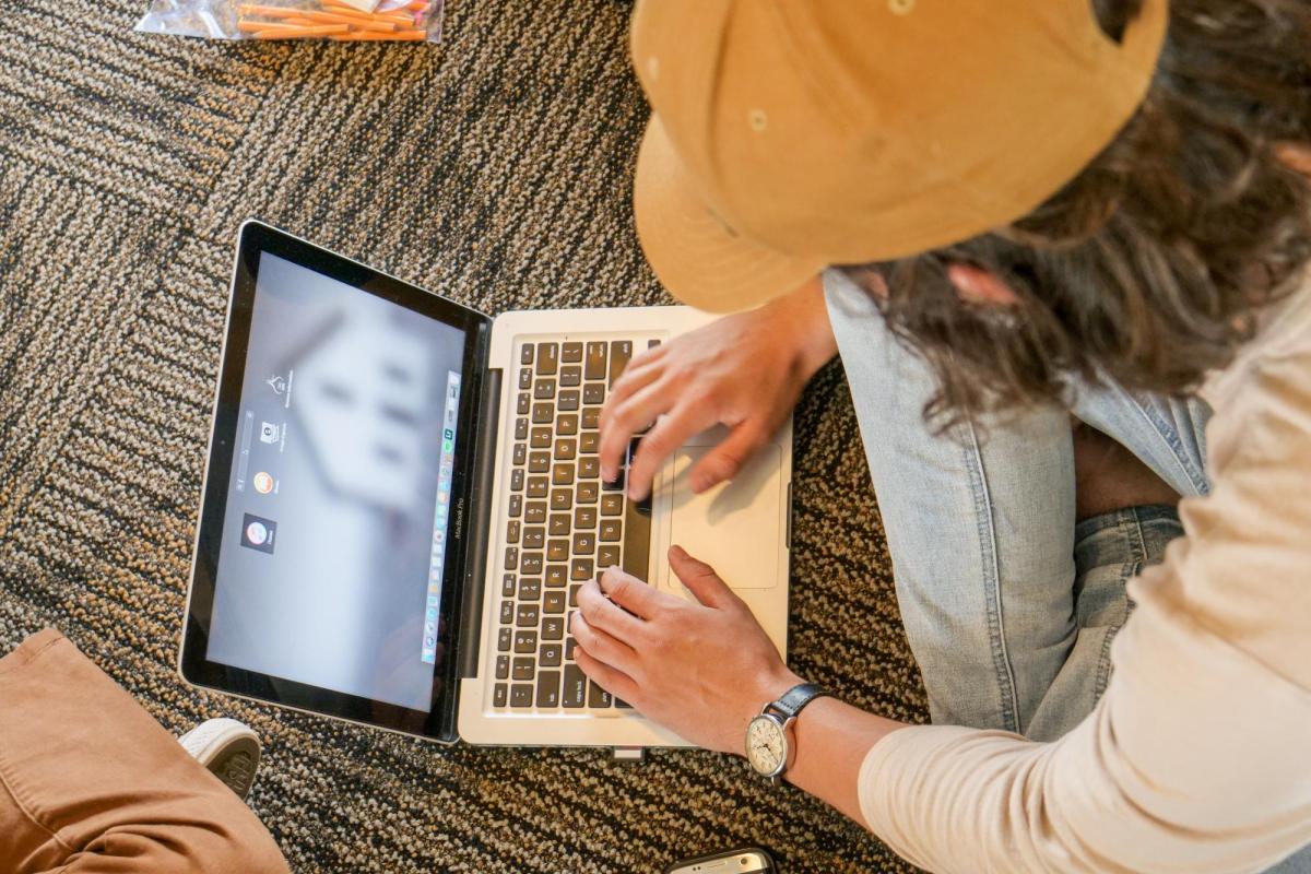 Looking down at a student working on a laptop computer