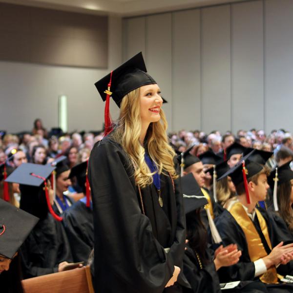 Graduates with distinction stand.