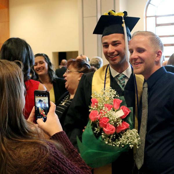 Families and students celebrate at the following reception.