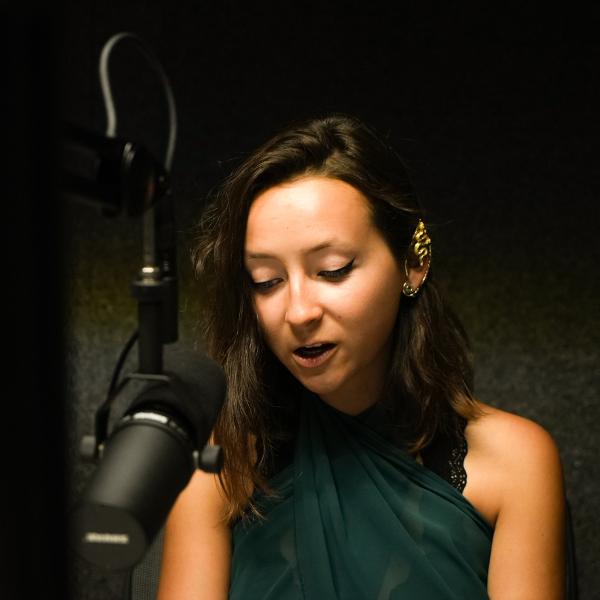 Pathways student Sierra Dunham records a voice-over in the podcast booth to play in the background of her TikTok video. 