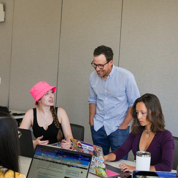 Pat Ferrucci, an associate professor in journalism, helps Pathways student Presley Nemecek on her sports journalism project.